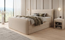 Boxspring posteľ Liana II s vysoko zdvíhateľným úložným priestorom v Teddy Bouclé